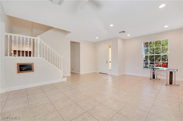 unfurnished living room with light tile patterned floors, recessed lighting, visible vents, stairway, and baseboards