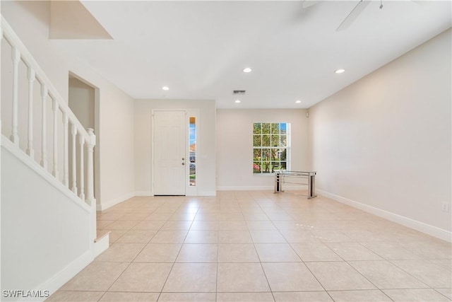 entryway featuring light tile patterned floors, recessed lighting, visible vents, baseboards, and stairs