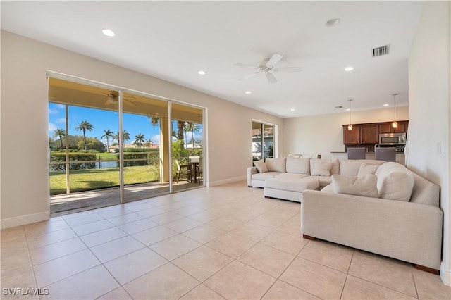 unfurnished living room with light tile patterned flooring, visible vents, a ceiling fan, and recessed lighting