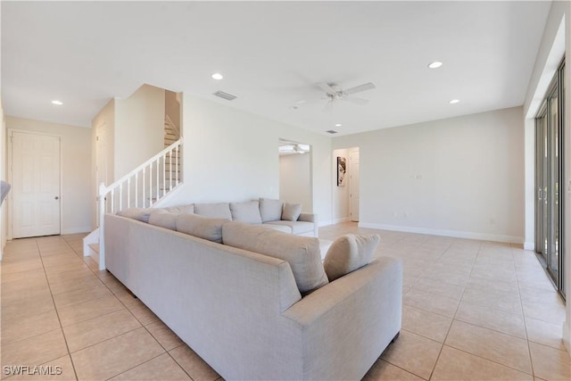 living area featuring stairs, light tile patterned flooring, visible vents, and recessed lighting