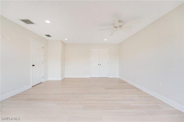 empty room with light wood-type flooring, visible vents, baseboards, and recessed lighting