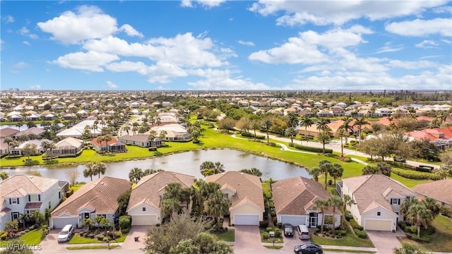 drone / aerial view with a residential view and a water view