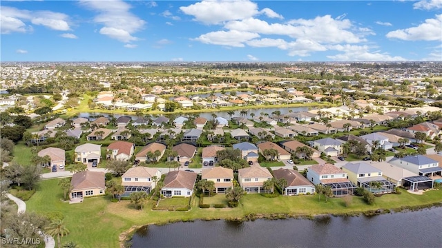 birds eye view of property with a water view and a residential view