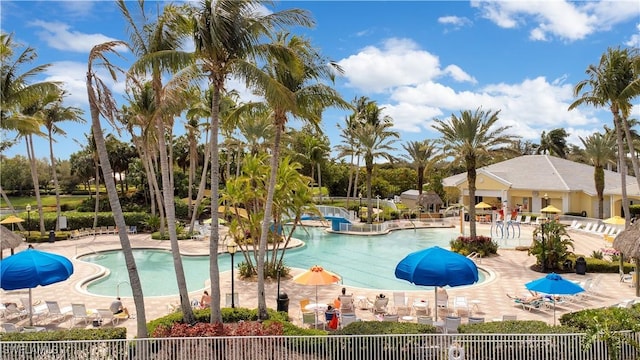 community pool featuring a patio area and fence