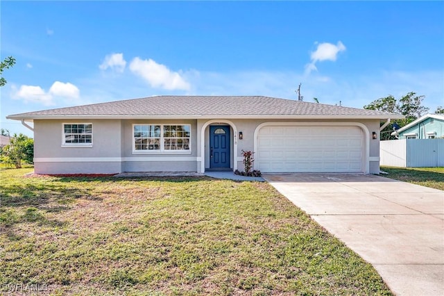 single story home featuring stucco siding, an attached garage, a front yard, fence, and driveway