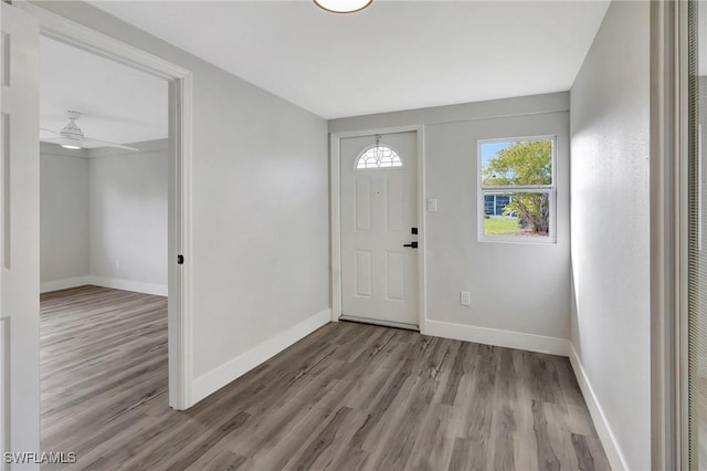 entryway with ceiling fan, baseboards, and wood finished floors