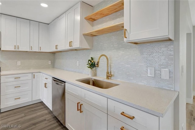 kitchen featuring dishwasher, white cabinets, and a sink