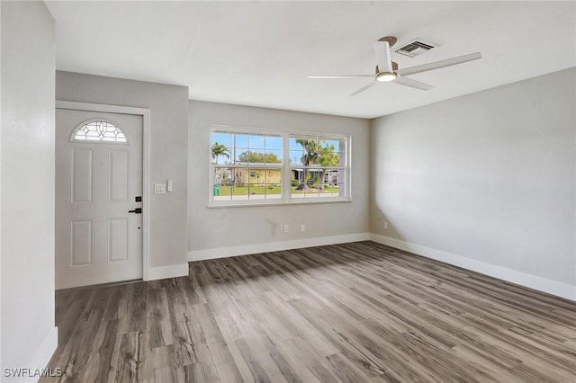 entrance foyer with baseboards, visible vents, ceiling fan, and wood finished floors