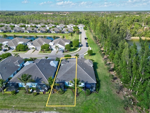 birds eye view of property with a residential view and a wooded view