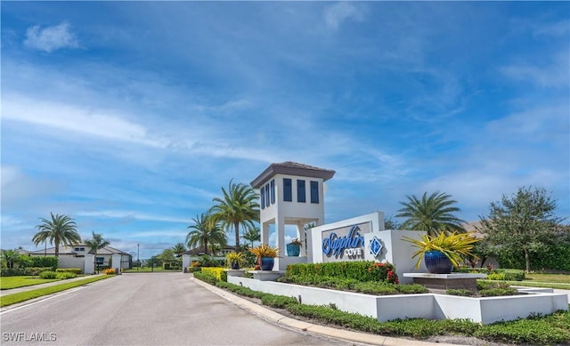 exterior space featuring curbs and a gated entry