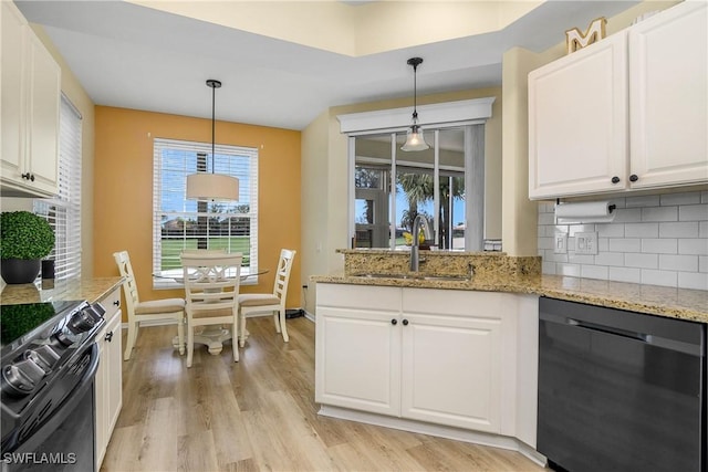 kitchen with black appliances, white cabinetry, and light stone counters