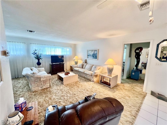 living area with light tile patterned flooring and visible vents