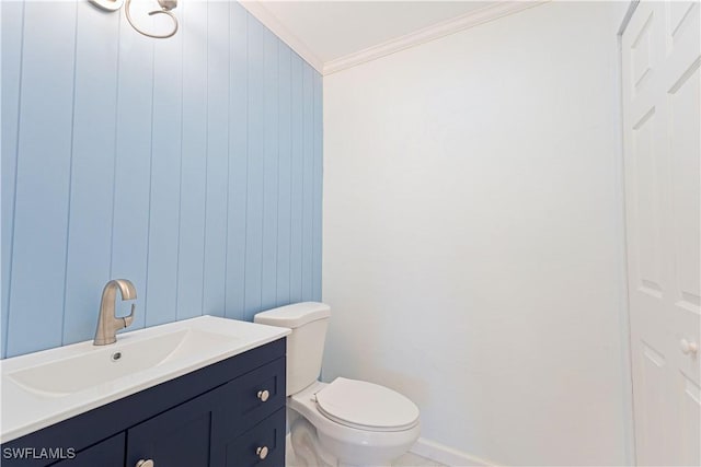 bathroom featuring ornamental molding, vanity, and toilet