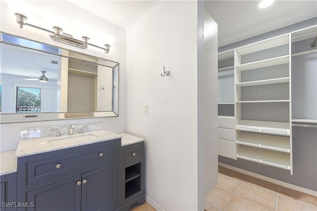 bathroom with a ceiling fan, vanity, baseboards, and tile patterned floors