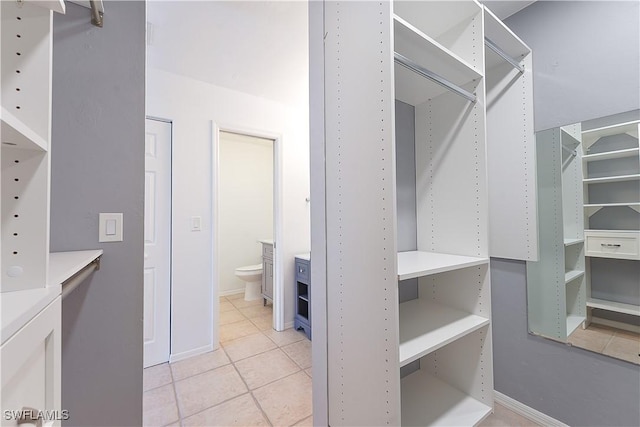 spacious closet with light tile patterned floors