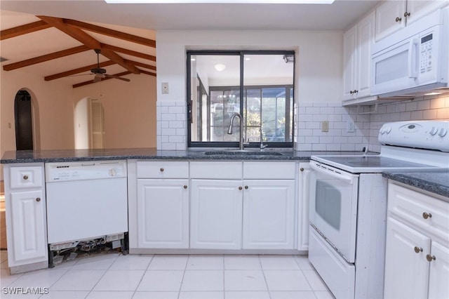 kitchen with lofted ceiling with beams, white appliances, white cabinets, and a sink