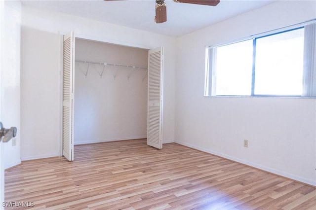 unfurnished bedroom with a ceiling fan, a closet, baseboards, and wood finished floors