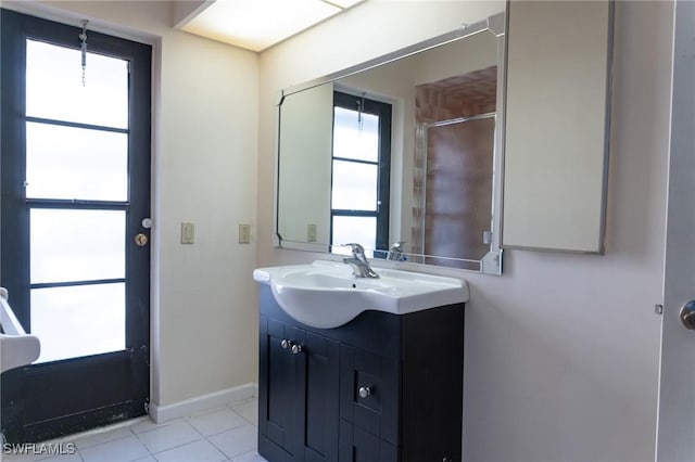 bathroom featuring tile patterned flooring, vanity, and baseboards