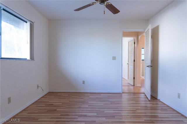 spare room with ceiling fan, baseboards, and wood finished floors