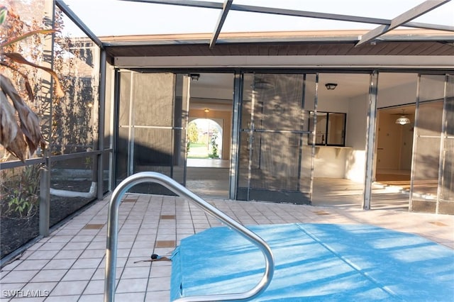 view of patio featuring a lanai