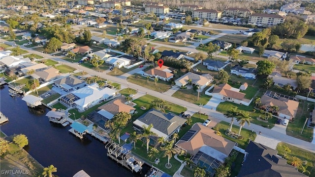 drone / aerial view featuring a residential view and a water view