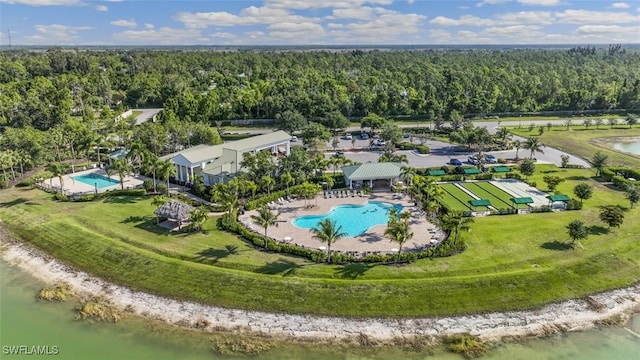 birds eye view of property with a water view and a forest view