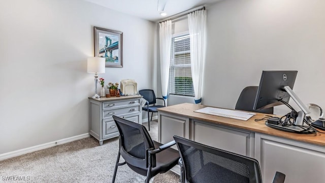 home office featuring baseboards and light colored carpet