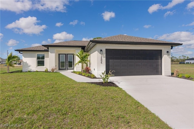 view of front facade with concrete driveway, a front lawn, and an attached garage