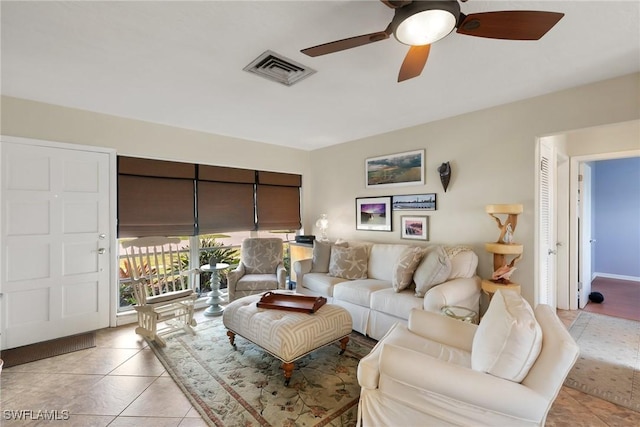 living area featuring light tile patterned floors, visible vents, and a ceiling fan