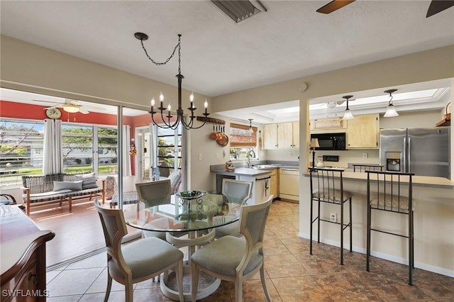 dining space featuring visible vents, light tile patterned flooring, and ceiling fan with notable chandelier