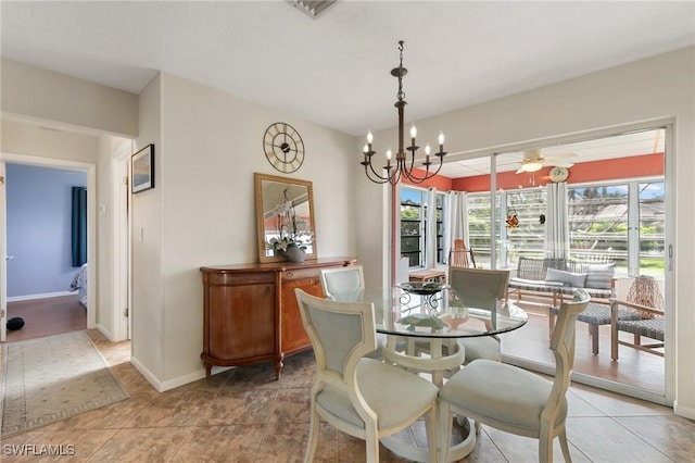 dining space with light tile patterned flooring, baseboards, and ceiling fan with notable chandelier