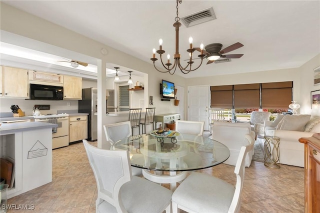 dining room featuring ceiling fan with notable chandelier, light tile patterned floors, and visible vents