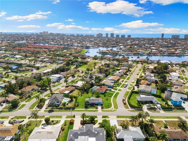 drone / aerial view with a water view, a view of city, and a residential view