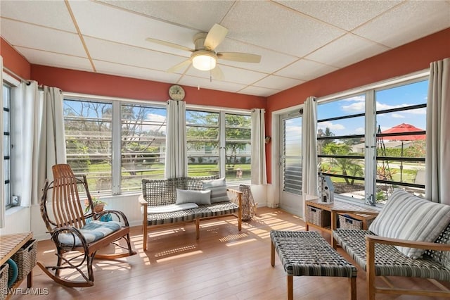 sunroom / solarium with a paneled ceiling and a ceiling fan