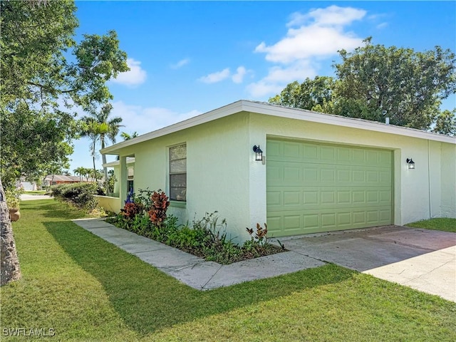 view of home's exterior with a yard, concrete driveway, an attached garage, and stucco siding