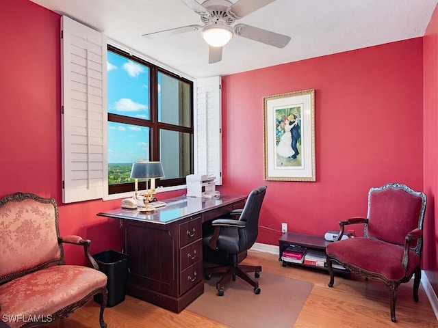 office area featuring wood finished floors, a ceiling fan, and baseboards