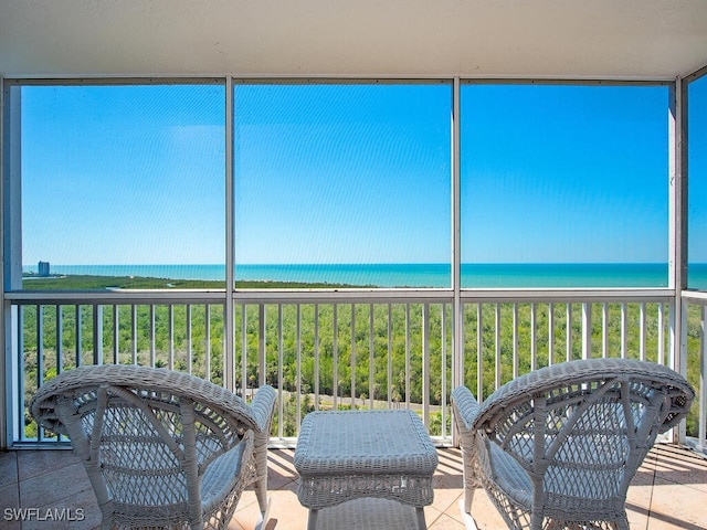 sunroom featuring a water view and a wealth of natural light