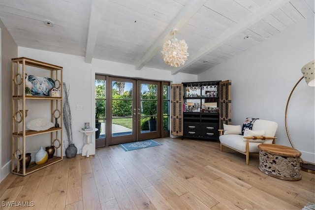 unfurnished room featuring vaulted ceiling with beams, a chandelier, wood finished floors, wood ceiling, and french doors