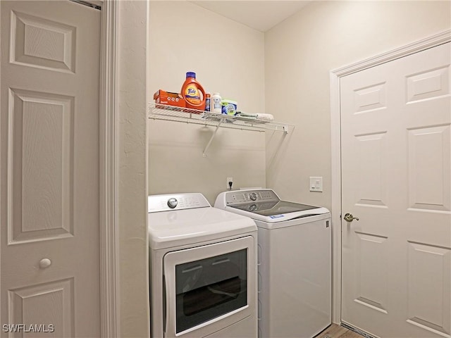 washroom with laundry area and separate washer and dryer