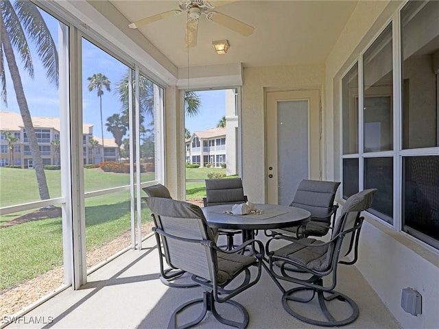 sunroom / solarium with a ceiling fan