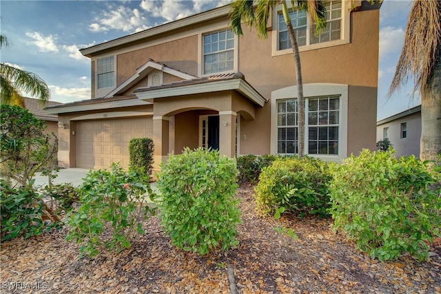 view of front of property featuring a garage and stucco siding