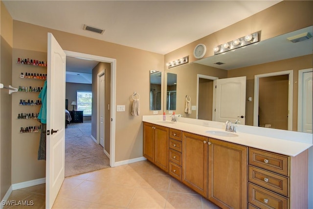 full bathroom with double vanity, visible vents, and a sink