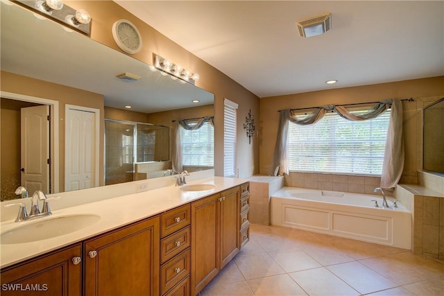 bathroom featuring tile patterned floors, visible vents, a shower stall, and a sink