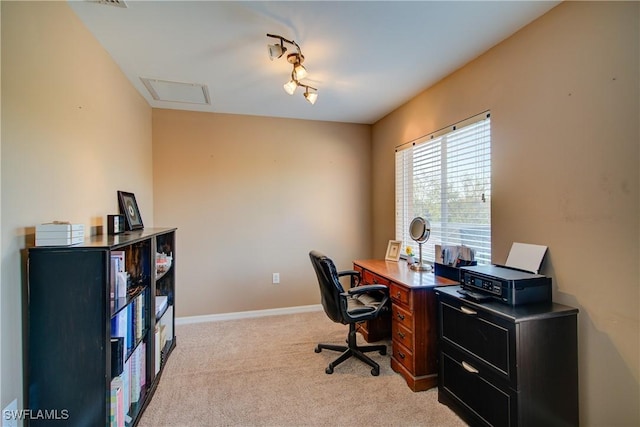 office space featuring baseboards, light colored carpet, and rail lighting