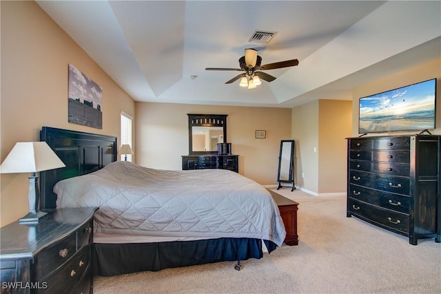 bedroom featuring visible vents, ceiling fan, baseboards, light carpet, and a raised ceiling