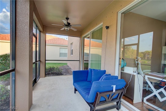 sunroom / solarium featuring a ceiling fan