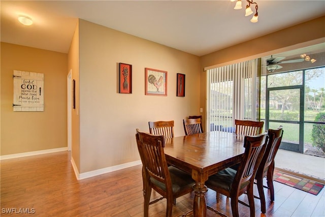 dining space featuring baseboards, light wood-type flooring, and ceiling fan