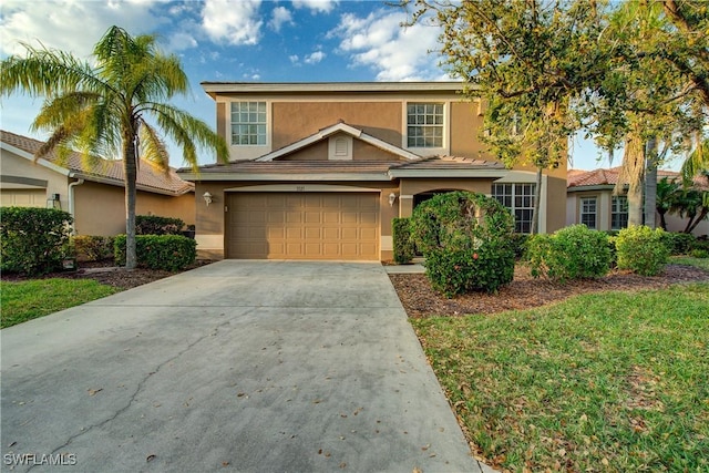 traditional-style house featuring stucco siding, concrete driveway, and a garage