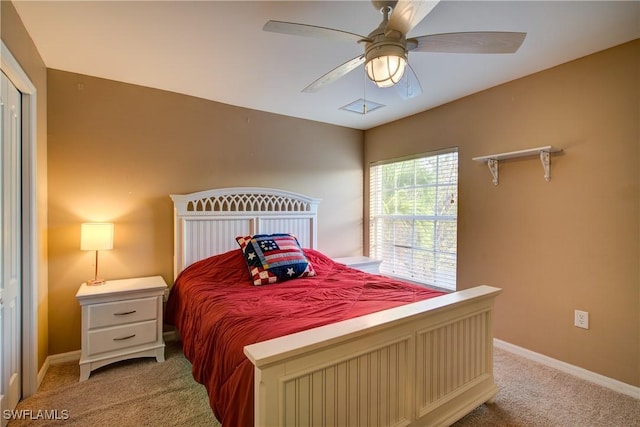 bedroom featuring light colored carpet, baseboards, and ceiling fan