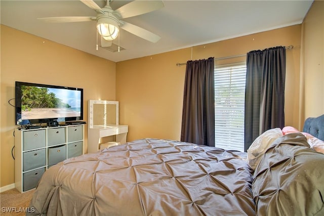 bedroom featuring baseboards, a ceiling fan, and carpet floors